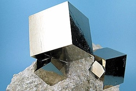 Pyrite, also known as fool's gold, forms cubic crystals that have a yellowish metallic sheen, sometimes leading prospectors to mistake it for gold.