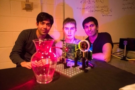MIT students (left to right) Ayush Bhandari, Refael Whyte and Achuta Kadambi pose next to their "nano-camera" that can capture translucent objects, such as a glass vase, in 3-D.