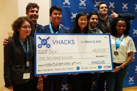 Claire Traweek, Sam Kim, Jessy Lin, Neil Gohklay, and Juliet Wanyiri pose with two of their mentors after winning second place in the migrants and refugees category as part of the Vatican's first-ever hackathon.