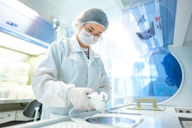 A LEES researcher reviews a 200 mm silicon III-V wafer.