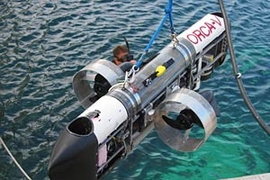 The six-foot-long ORCA-V has two main thrusters  at the side and two vertical thrusters at the bow and stern. There are two main  dry compartments in the sub; the top one contains a computer that controls the  sub, while the bottom one contains the batteries and the motor drivers.