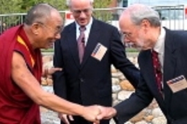 The Dalai Lama, left, is greeted by MIT President Charles M. Vest, center, and Phillip A. Sharp, director of the McGovern Institute for Brain Research at MIT, which co-sponsored the event with the Mind and Life Institute.