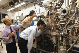 Senior research scientist Jagadeesh Moodera, left, points to the molecular beam epitaxy setup he uses in his research. With him are Tiffany Santos, graduate student in materials science and engineering, and postdoctoral associate John Philip.