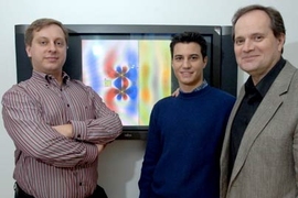 Researchers present a graphic illustrating how magnetism can transmit energy wirelessly. Marin Soljacic, left, assistant professor of physics, Aristeidis Karalis, G, and John Joannopoulos, professor of physics, use theoretical calculations and computer simulations to find ways to recharge electronics wirelessly.