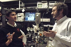 Graduate student Manu Prakash (left) and Professor Neil Gershenfeld discuss new applications for their microfluidic chips, which can carry on-chip process control information.