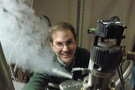 Assistant Professor of Physics Eric Hudson transfers liquid helium to cool the scanning tunneling microscope he is using in his research on high-temperature superconductivity.