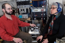 Here Senior Research Scientist Charlotte Reed speaks while the device she helped develop converts the sounds into vibrations. Graduate research assistant Theodore Moallem uses the device to read her lips and feel the sounds.