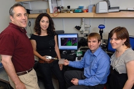 Professor Elazer Edelman, Natalie Artzi, Aaron Baker and Adriana Bon in the lab with a surgical adhesive they have developed.