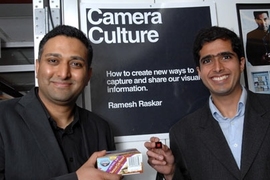 Ramesh Raskar, left, holds box with conventional barcode,
while Ankit Mohan holds a prototype of new Bokode.