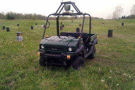 A utility vehicle equipped with a laser range finder drives through a field, avoiding obstacles without human intervention.