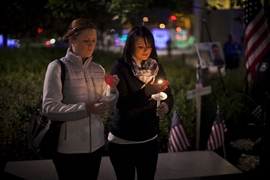 Officer Sean Collier&#8217;s sisters held the candles from which all others were lit.