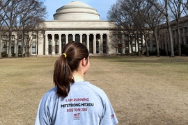 Sophomore Sally Miller of MIT Strong stops in front of MIT’s Great Dome at the start of a training run on March 29. The team is made up of students, faculty, staff, and alumni. Miller is one of the volunteer co-organizers of the team.