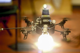 In the researchers' experiments, the robot helicopter was equipped with a continuous-light source, a photographic flash, and a laser rangefinder.