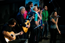 Collins (middle) sings with Pardis Sabeti (right), a Broad Institute researcher; guitarist Bob Katsiaficas (left); and the MIT Logarhythms a cappella group.