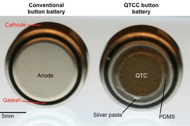At left, a typical button battery; at right, a button battery coated with quantum tunneling composite (QTC).