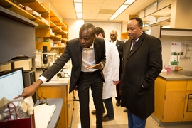 Ibrahim Cissé, an assistant professor of physics at MIT (left), explains his research group's work to Niger's President Mahamadou Issoufou at MIT on April 3