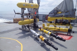 Several classes of autonomous underwater vehicles await deployment on the deck of the Falkor, off the coast of western Australia.