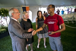 (From left) President Reif, Christine Reif, and Chancellor Cynthia Barnhart meet a student. 