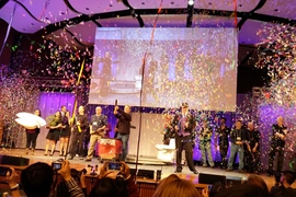 Mechanical engineering professor David Wallace (right of center in top hat) was surprised with a tribute video for his 20 years of teaching the “product engineering processes” class, before course instructors shot streams of confetti over the audience.