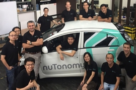 The nuTonomy team, including Emilio Frazzoli (third from left, standing), with one of their driverless cars
