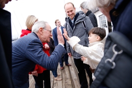 MIT President L. Rafael Reif high-fives a young spectator.