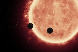 An artist’s depiction of planets transiting a red dwarf star in the TRAPPIST-1 System

