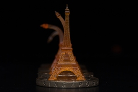 A shape memory Eiffel tower, pictured, was 3-D printed using projection microstereolithography. Here you can see it recovering from being bent after toughening on a heated Singapore dollar coin.
