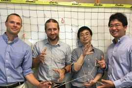 Left to right: Professors Bradley Olsen and Jeremiah Johnson, postdoc Rui Wang, and grad student Ken Kawamoto demonstrate polymer elasticity using rubber bands. 
