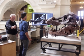 Researchers demonstrate their scanning technique, with a user holding a monopod-mounted Kinect at close range from a T. Rex skull. 

