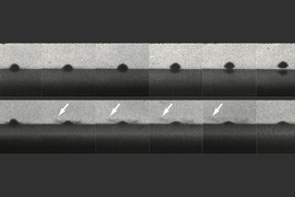 The top row of photos shows a particle that melts the surface on impact and bounces away without sticking. The bottom row shows a similar particle that does not melt and does stick to the surface. Arrows show impact sprays that look like liquid, but are actually solid particles. 
