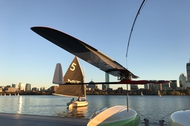 An albatross glider, designed by MIT engineers, skims the Charles River.