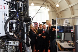 Prime Minister António Costa (center) visited the Computer Science and Artificial Intelligence Laboratory and met members of the Robot Locomotion Group, including Professor Russ Tedrake (right), who described the Atlas robot (left), which competed in the DARPA Robotics Challenge.