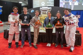 Winter, right, and MechE Associate Professor Sangbae Kim, left, pose with the competition finalists — Sam Ubellacker, (First Place), Dominic Panzino (Second Place), Jessica Xu (Third Place), and Amber Bick (Fourth Place).