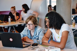 Girls work together to build a mobile app at summer camp