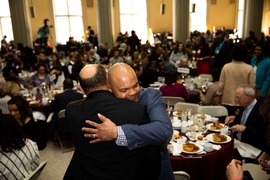 Keynote speaker Kevin Richardson is greeted by a member of the audience after his speech.