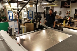 Graduate student Zach Fredin operates the Zund large-format cutter in MIT’s Center for Bit and Atoms. The machine was used to make prototypes of the face shield.
