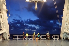 Scientists prepare to deploy an underway CTD from the back deck of a research vessel.