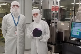 MIT researchers demonstrated a method to manufacture carbon nanotube transistors in commercial facilities that fabricate silicon-based transistors. This photograph shows Anthony Ratkovich, left, and Mindy D. Bishop, who is holding an example of a silicon wafer. 