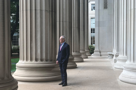 Rafael Reif stands among the columns in MIT's Killian Court