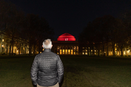 President Reif with his back to the camera facing the great dome, illluminated in red and with the nuber 17