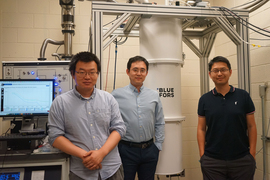 Inside the lab with computers and equipment stand, from left to right, Zhengguang Lu, Long Ju, and Tonghang Han.
