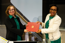 Paula Hammond holds the Killian award, a red leather binder with the MIT seal, with Mary C. Fuller.