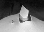 This photo compares the new trocar (left) with another commonly used trocar. The standard trocar (right) has pierced the body (actually a synthetic test material) by about 14mm without the safety guard deploying; the guard on the new trocar has already deployed.