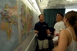 Sophomore in mechanical engineering Jon Wu (left) shares a laugh with incoming freshmen Brian Schmidt and Laura Daher in front of the map on which freshmen were asked to put a tack to mark where they come from.