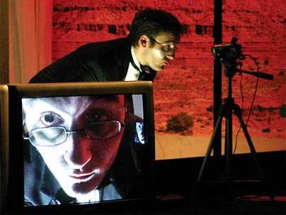 Image from Tennessee Williams' 'Demolition Downtown,' an MIT Dramashop performance directed by MIT professor Jay Schieb, showing the use of video cameras and screens on stage.