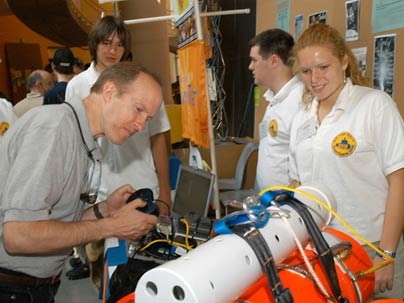 The team from Bow High School in New Hampshire, including Lauren Zeilinski at right, displays its Remotely Operated Vehicle for Education and Research (ROVER) at the InvenTeams Odyssey at MIT.