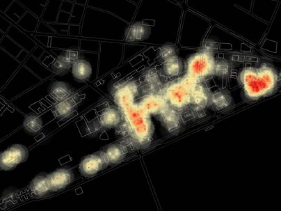 A screenshot from an animation showing the changing patterns of  wireless Internet activity during 24 hours on the MIT campus. Red indicates a large number of users per access point, black a small number.