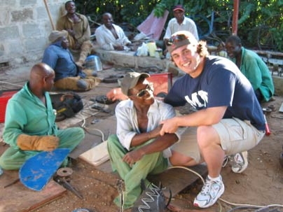 Graduate student Amos Winter, right, poses with Tanzanians during his trip to the country last year to assess wheelchair needs.