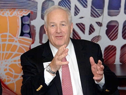 John Bell, mayor of Gloucester, Mass., sought ideas for connecting Main Street to the harbor. Behind Bell and Frenchman is Frank Stella's 1994 wraparound painting, 'Loohooloo.'