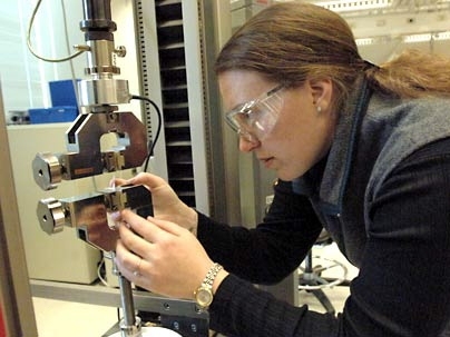 MIT graduate student Shawna Liff works with a nanocomposite material  she helped develop. The material, composed of nanoparticles embedded in a rubbery polymer, mimics the strength and stretchiness qualities of spider silk.
